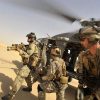 Operators from Task Force 121 and US Air Force Pararescue Jumpers (PJs) exiting from a helicopter