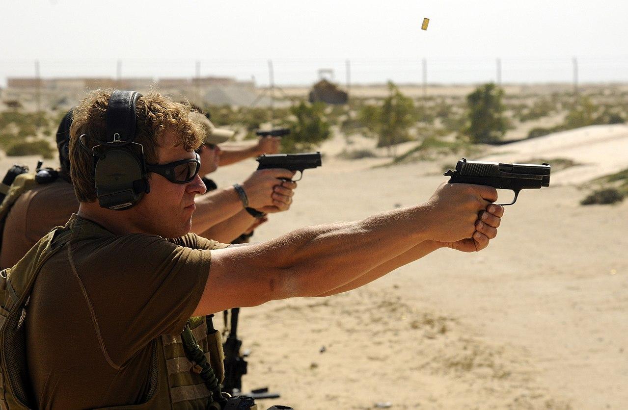 Navy SEALs at the shooting range firing from their Sig P226