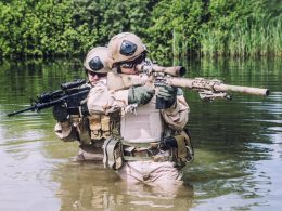 Two U.S. Navy Seals navigating through swamp during the training