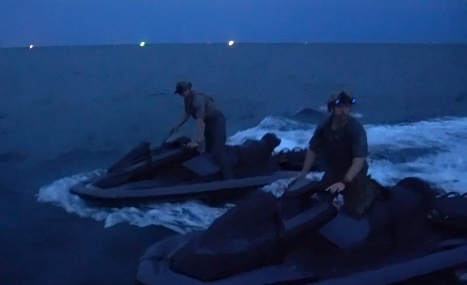 U.S. Navy SEALs on Jet Skis at undisclosed location night