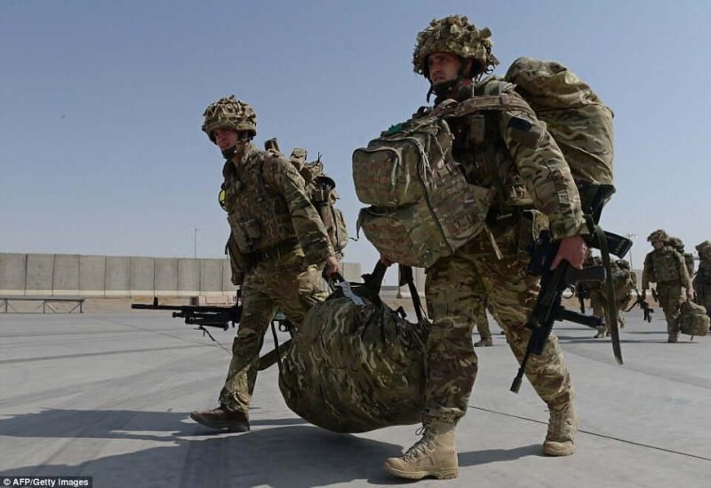 soldiers wearing heavy equipment