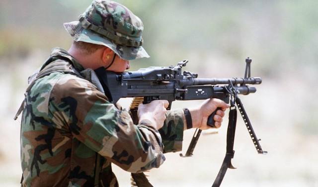 A soldier aiming with M60E3 machine gun