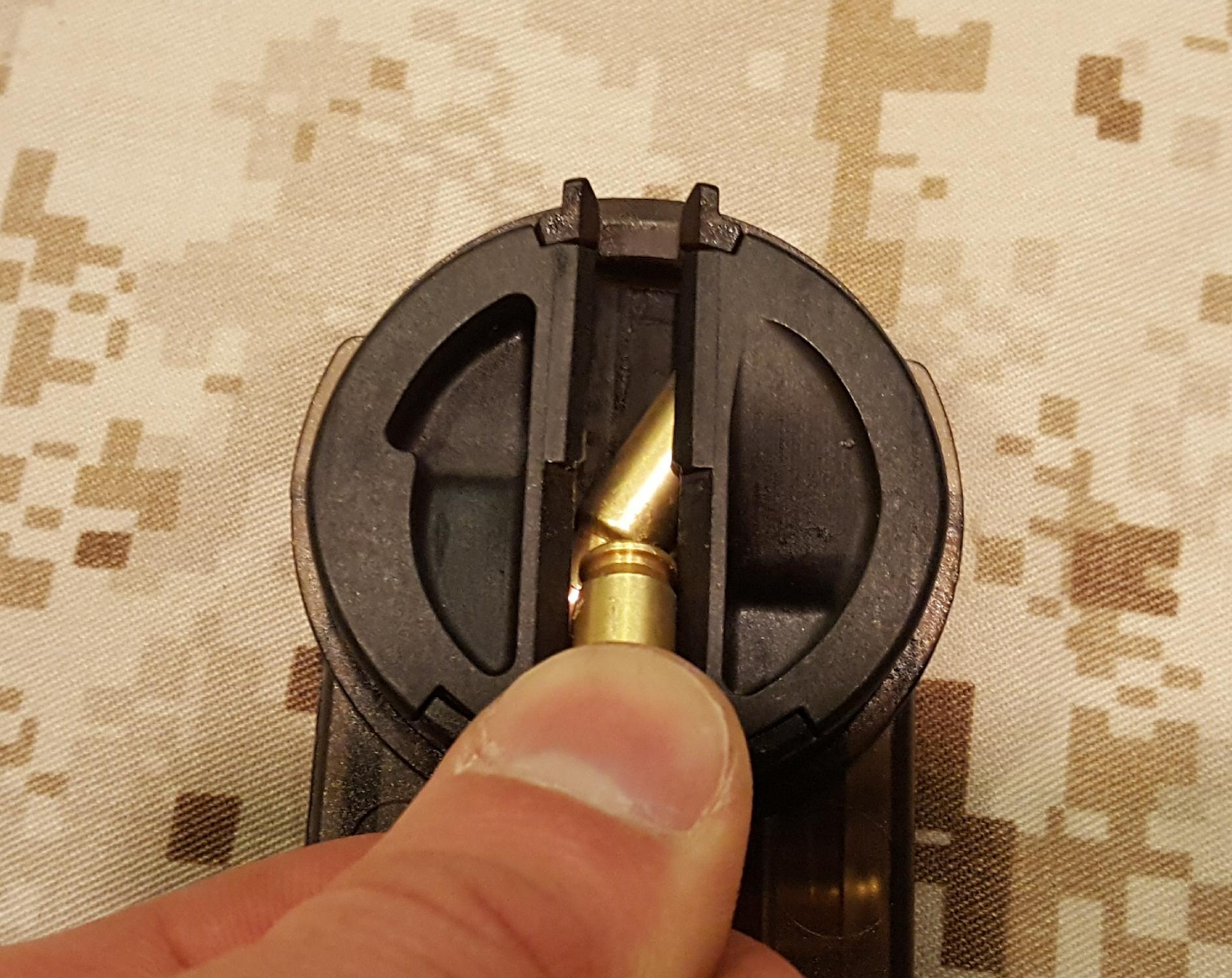 FN P90 magazine rounds are situated horizontally in the magazine, so they have to be rotated with a ramp located at the rear of the magazine