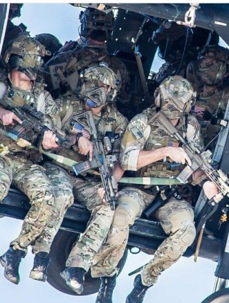 A group of Delta Force operators armed with HK416 assault rifles hanging out from the Blackhawk