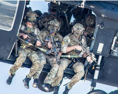 A group of Delta Force operators armed with HK416 assault rifles hanging out from the Blackhawk