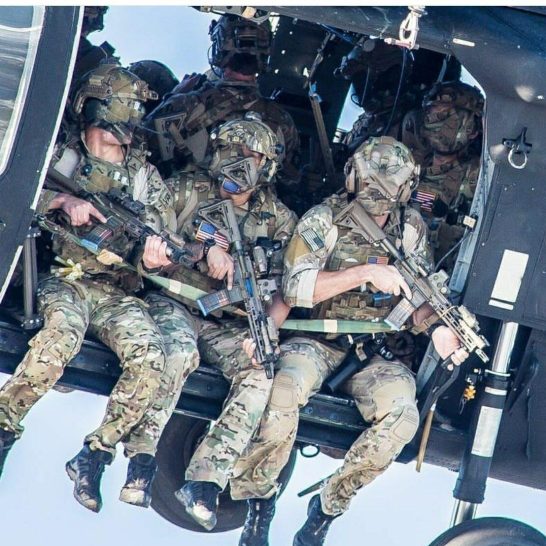 A group of Delta Force operators armed with HK416 assault rifles hanging out from the Blackhawk