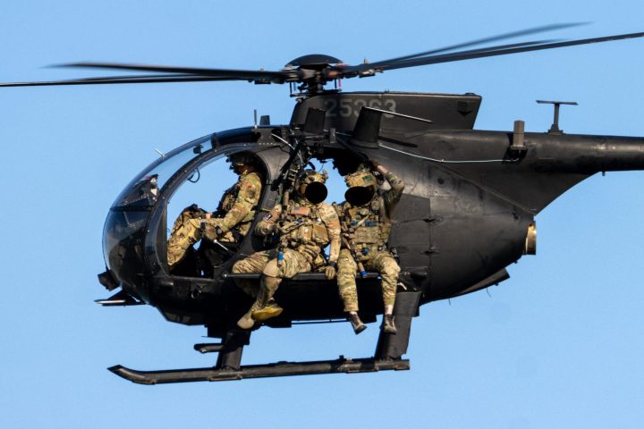 SEAL operators sitting on the planks of the Little Bird