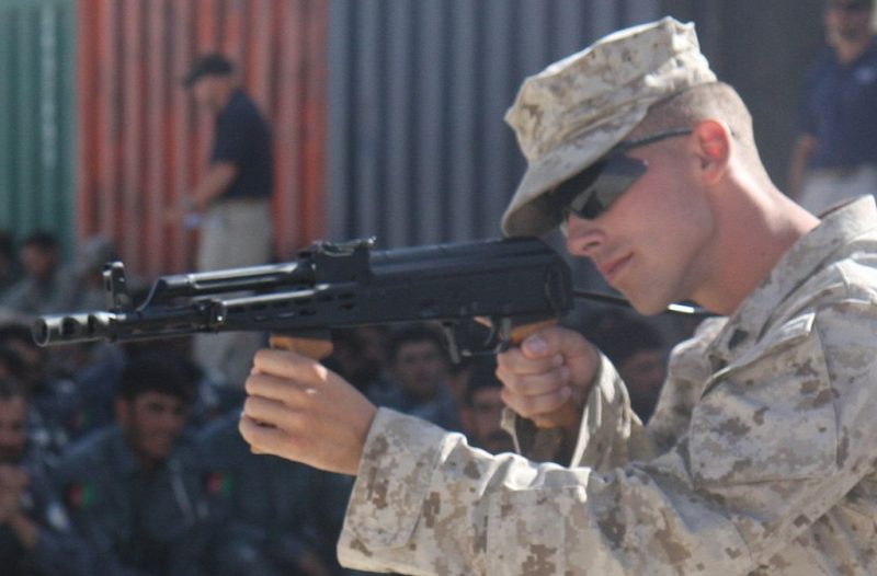 U.S. Marine Corps Cpl. Cory J. Becker, of Golf Company, 2nd Battalion, 7th Marine Regiment, shows Afghan National Police recruits different firing positions using an AMD-65 assault rifle on Lashkar Gah, Afghanistan, June 3, 2008