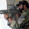 An Afghan National Police officer in September 2010, equipped with a modified AMD-65 with an attached hybrid telescopic sight that has the EOTech Holographic weapon sight.