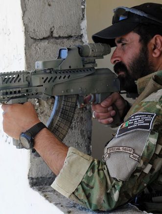 An Afghan National Police officer in September 2010, equipped with a modified AMD-65 with an attached hybrid telescopic sight that has the EOTech Holographic weapon sight.