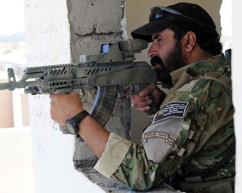 An Afghan National Police officer in September 2010, equipped with a modified AMD-65 with an attached hybrid telescopic sight that has the EOTech Holographic weapon sight.