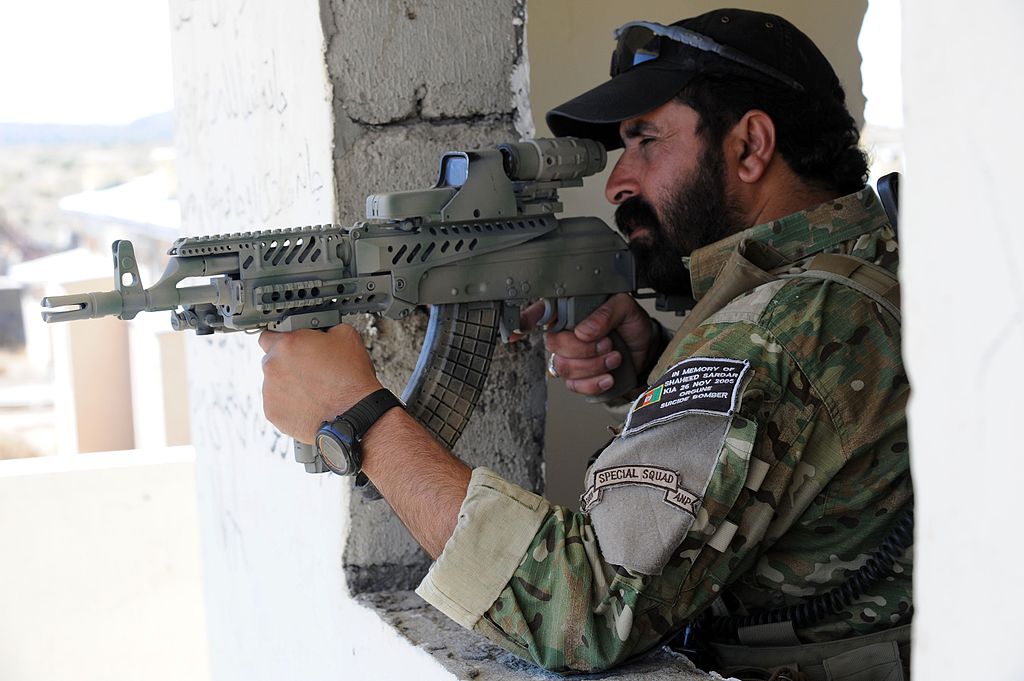 An Afghan National Police officer in September 2010, equipped with a modified AMD-65 with an attached hybrid telescopic sight that has the EOTech Holographic weapon sight.