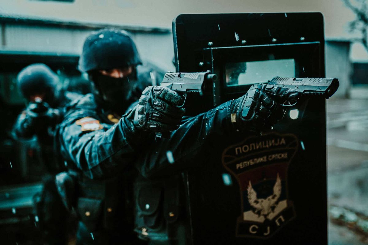 Operators from SAJ aiming with RS9 Vampir while taking cover behind the tactical shield