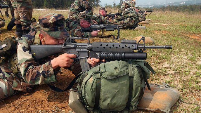 US Marine takes aim with an M16A2 fitted with the M203 40 mm grenade launcher