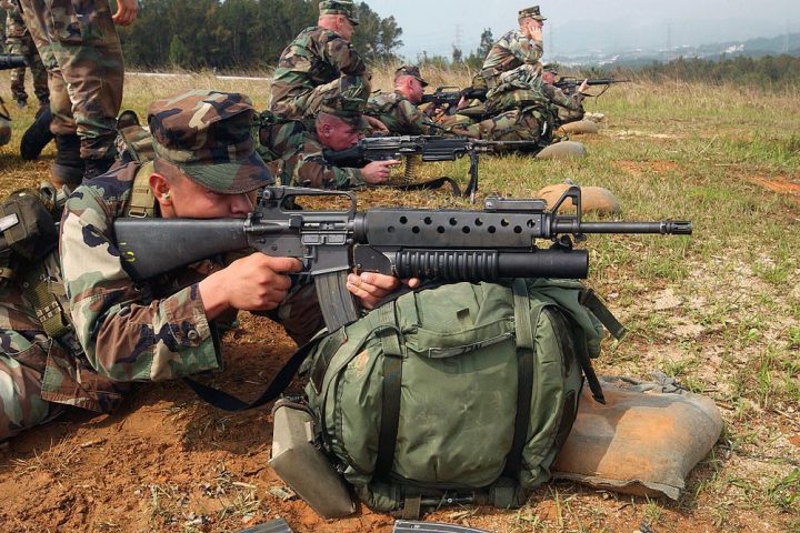 US Marine takes aim with an M16A2 fitted with the M203 40 mm grenade launcher