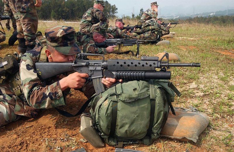 US Marine takes aim with an M16A2 fitted with the M203 40 mm grenade launcher