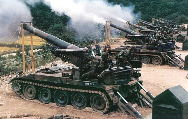 A bunch of M110 Howitzers in firing position