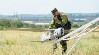 A Russian soldier inspects Orlan-10 drone
