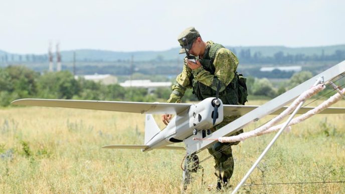 A Russian soldier inspects Orlan-10 drone