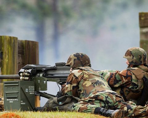 US Navy sailors fire a Mk 19 40 mm grenade launcher during a training exercise in March 2003