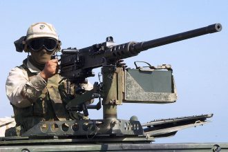 A marine prepares to fire from M2 Browning machine gun