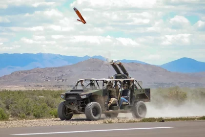 A light vehicle fitted with a pair of Pneumatically Integrated Launch Systems (PILS) launches an ALTIUS-600 as part of a U.S. Army test