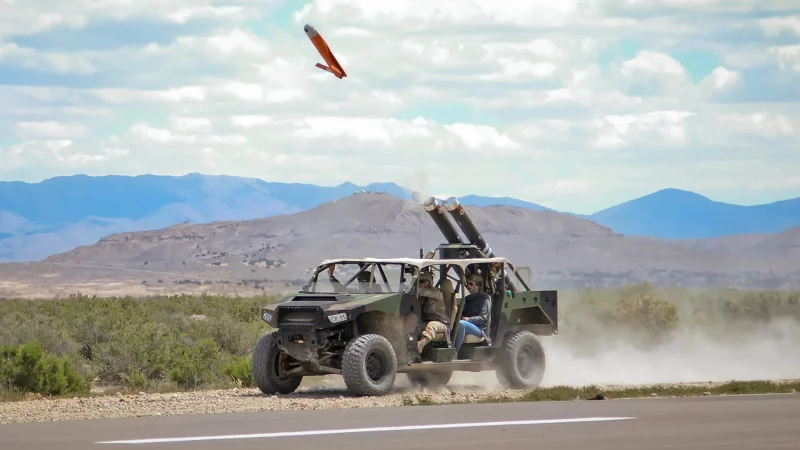 A light vehicle fitted with a pair of Pneumatically Integrated Launch Systems (PILS) launches an ALTIUS-600 as part of a U.S. Army test