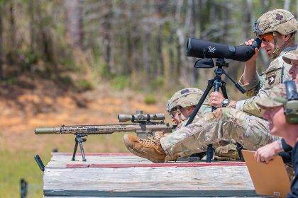 1st Lt. Aaron Arturi (front) and 1st Lt. John Ryan from the 101st Airborne Division (Air Assault), takes aim at stress shoot event at the Annual Best Ranger Competition in Fort Benning, Ga on April 9th, 2022. Ryan is aiming down range at the targets while Arturi is spotting him. The spotter helps the sniper stay on track so they can hit their target