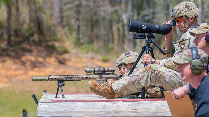 1st Lt. Aaron Arturi (front) and 1st Lt. John Ryan from the 101st Airborne Division (Air Assault), takes aim at stress shoot event at the Annual Best Ranger Competition in Fort Benning, Ga on April 9th, 2022. Ryan is aiming down range at the targets while Arturi is spotting him. The spotter helps the sniper stay on track so they can hit their target