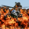 Apache helicopter flying through fire and smoke