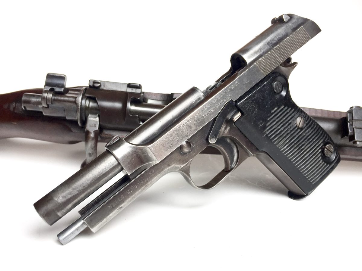 Two Beretta M1951 pistols on a white background