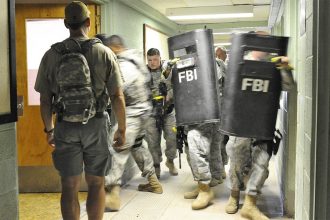 FBI agents training with ballistic shields in a building