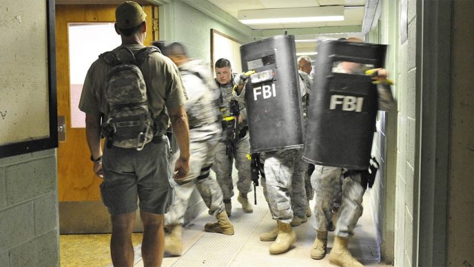 FBI agents training with ballistic shields in a building