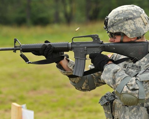 Soldier firing an M16 rifle at a target