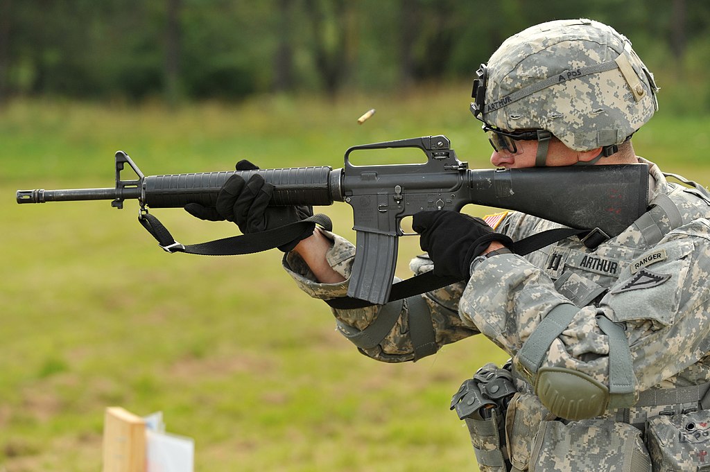 Soldier firing an M16 rifle at a target
