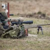 A Ukrainian soldier aiming with McMillan TAC-50 sniper rifle