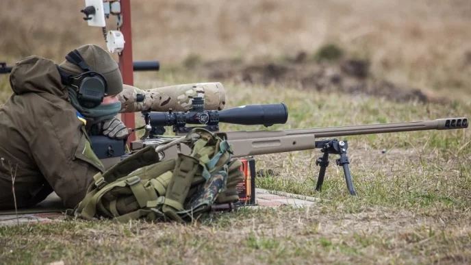 A Ukrainian soldier aiming with McMillan TAC-50 sniper rifle