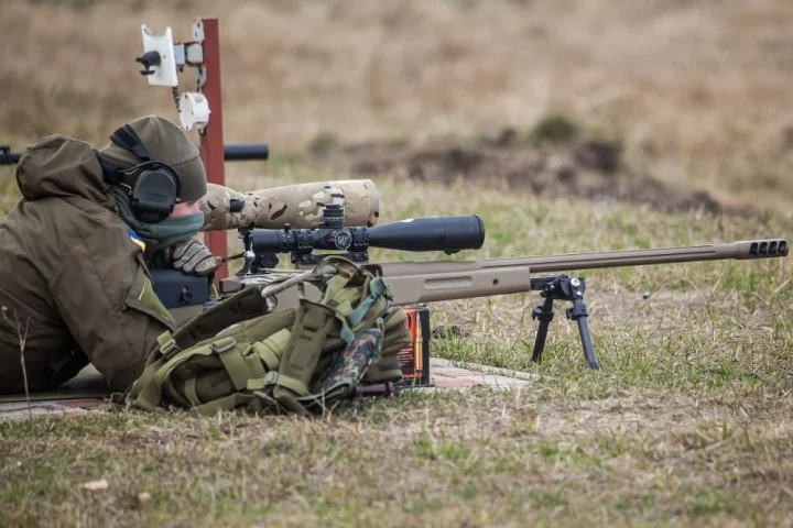 A Ukrainian soldier aiming with McMillan TAC-50 sniper rifle