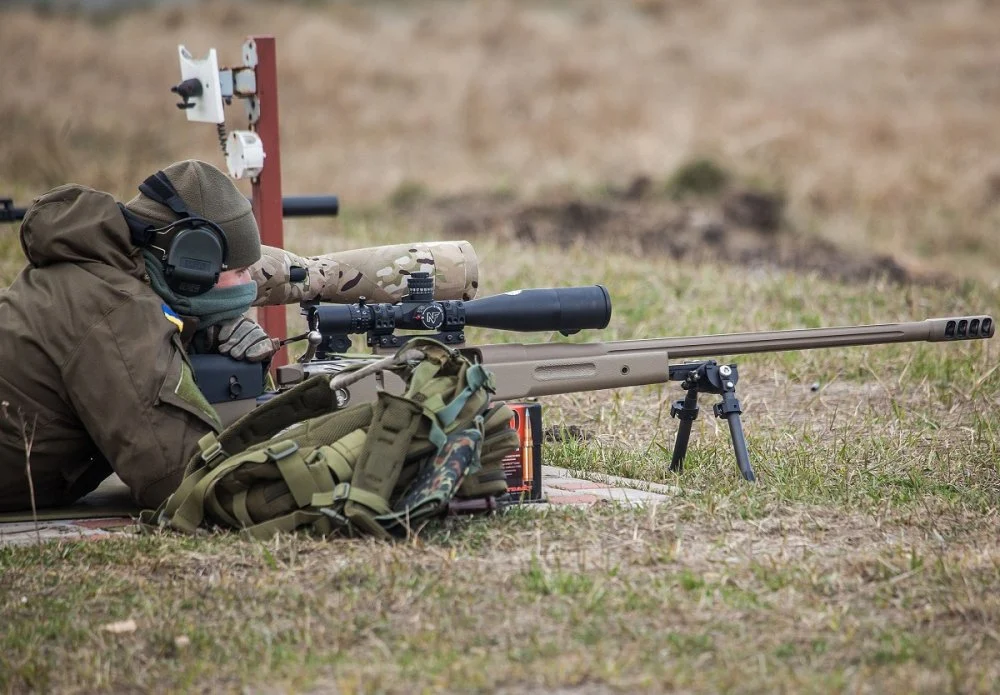 A Ukrainian soldier aiming with McMillan TAC-50 sniper rifle