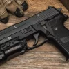 SIG Sauer P228 with flashlight attached on Picatinny rail