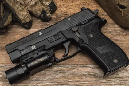 SIG Sauer P228 with flashlight attached on Picatinny rail