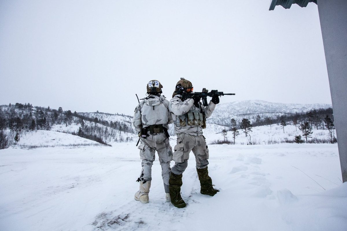 Two operators from Frogman Corps standing in the field during the mountain warfare training