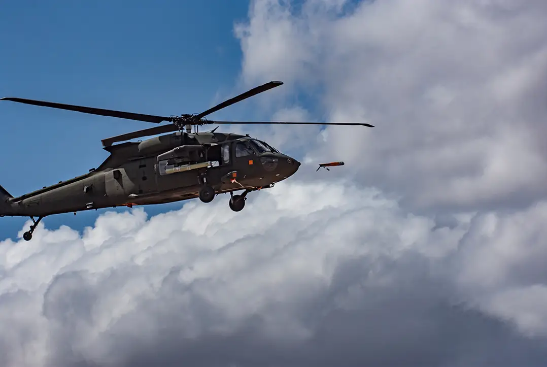 A U.S. Army UH-60 Black Hawk helicopter launches an ALTIUS-600 via a Common Launch Tube (CLT) during a test