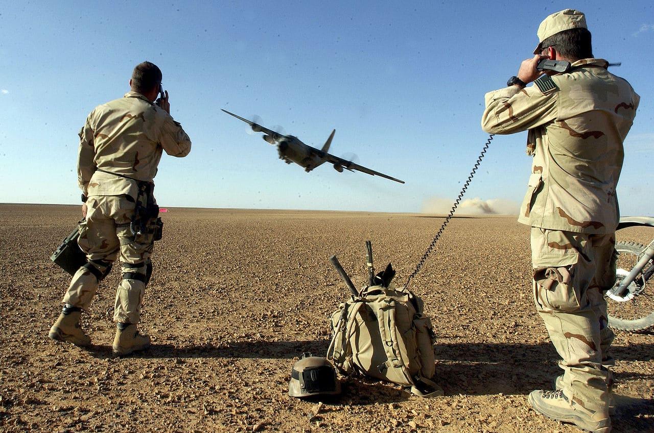 United States Air Force Combat Controllers (CCT) participating in Operation Enduring Freedom provide air traffic control to a C-130 taking off from a remote airfield 