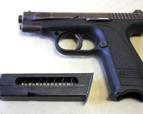 A black handgun with a silver slide and a magazine inserted into the grip, commonly referred to as the Gsh-18 or Russian Glock