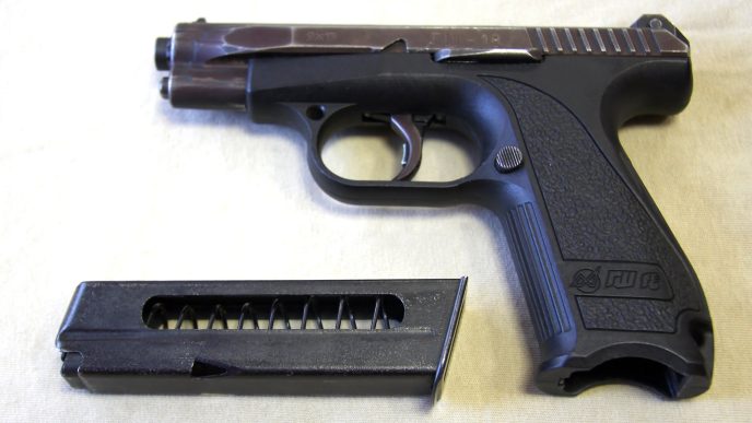 A black handgun with a silver slide and a magazine inserted into the grip, commonly referred to as the Gsh-18 or Russian Glock