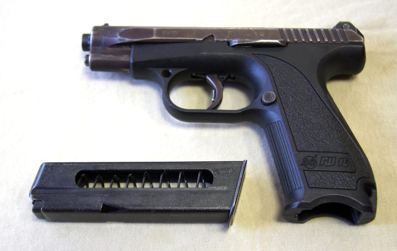 A black handgun with a silver slide and a magazine inserted into the grip, commonly referred to as the Gsh-18 or Russian Glock