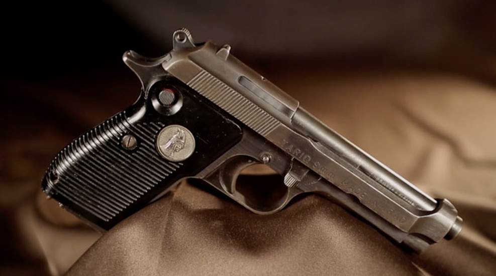 A Tariq 9mm pistol on a brown background